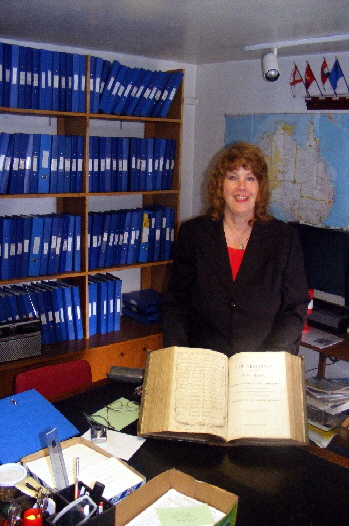 A USA visitor examining her family Bible at Murdoch House